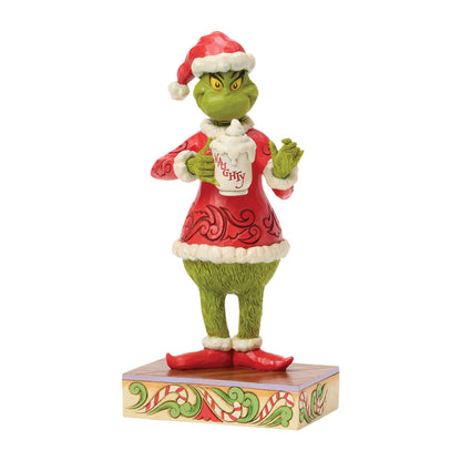 Jim Shore Grinch Figur 6018950 im Weihnachtsmannkostüm hält eine Tasse heiße Schokolade mit Sahne und der Aufschrift Naughty.